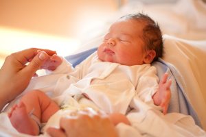 newborn baby on mother's lap