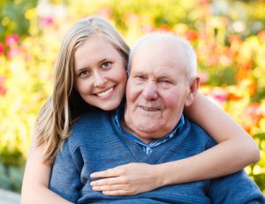 Beautiful granddaughter visiting her elderly kind grandfather.